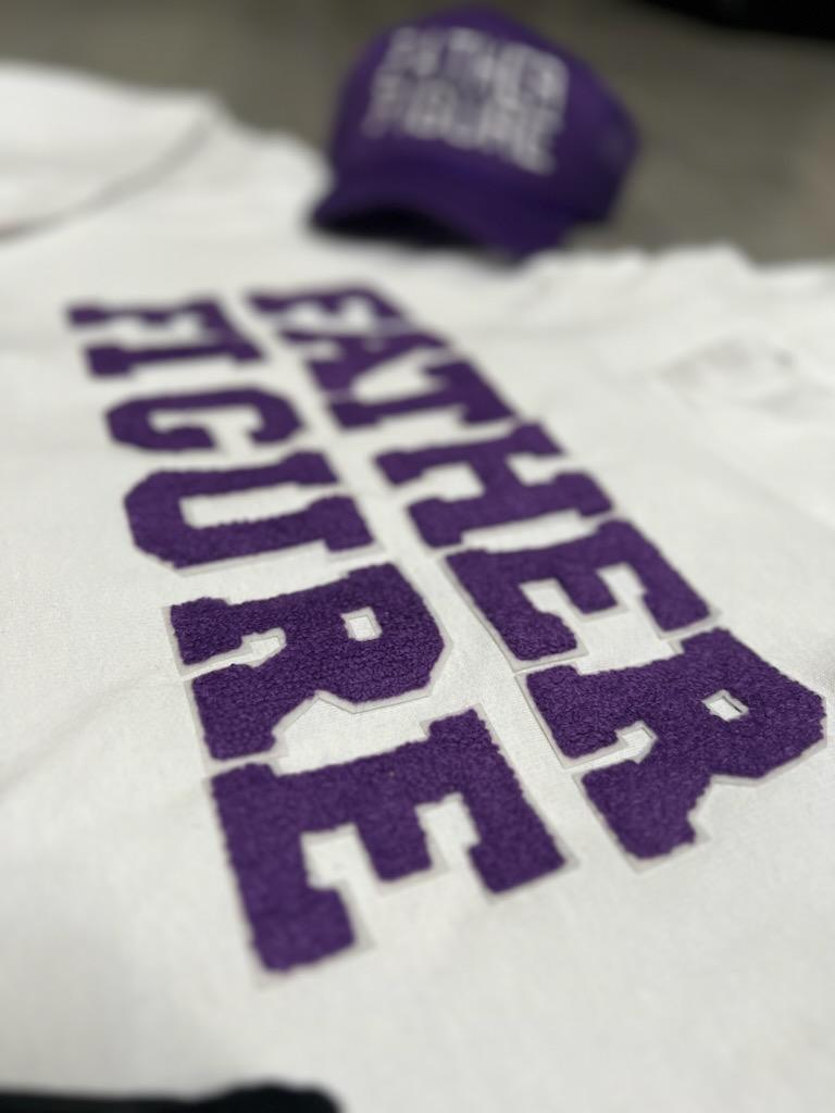 Cozy white cotton hoodie from the Fall/Winter "Purple Swag Pack" with bold purple chenille "Father Figure" text on the front.