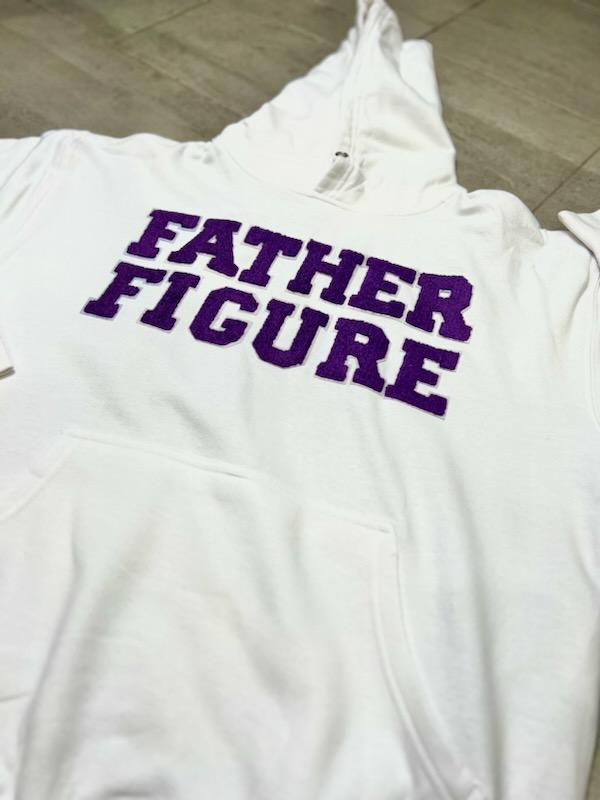 Cozy white cotton hoodie from the Fall/Winter "Purple Swag Pack" with bold purple chenille "Father Figure" text on front.